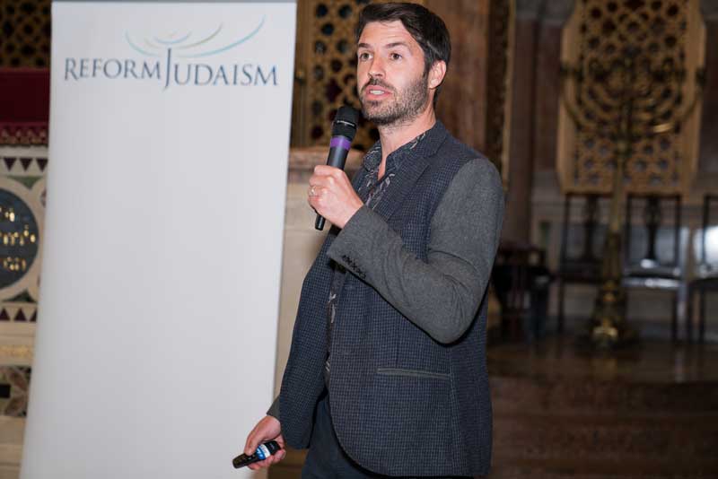 Louis speaking at an event